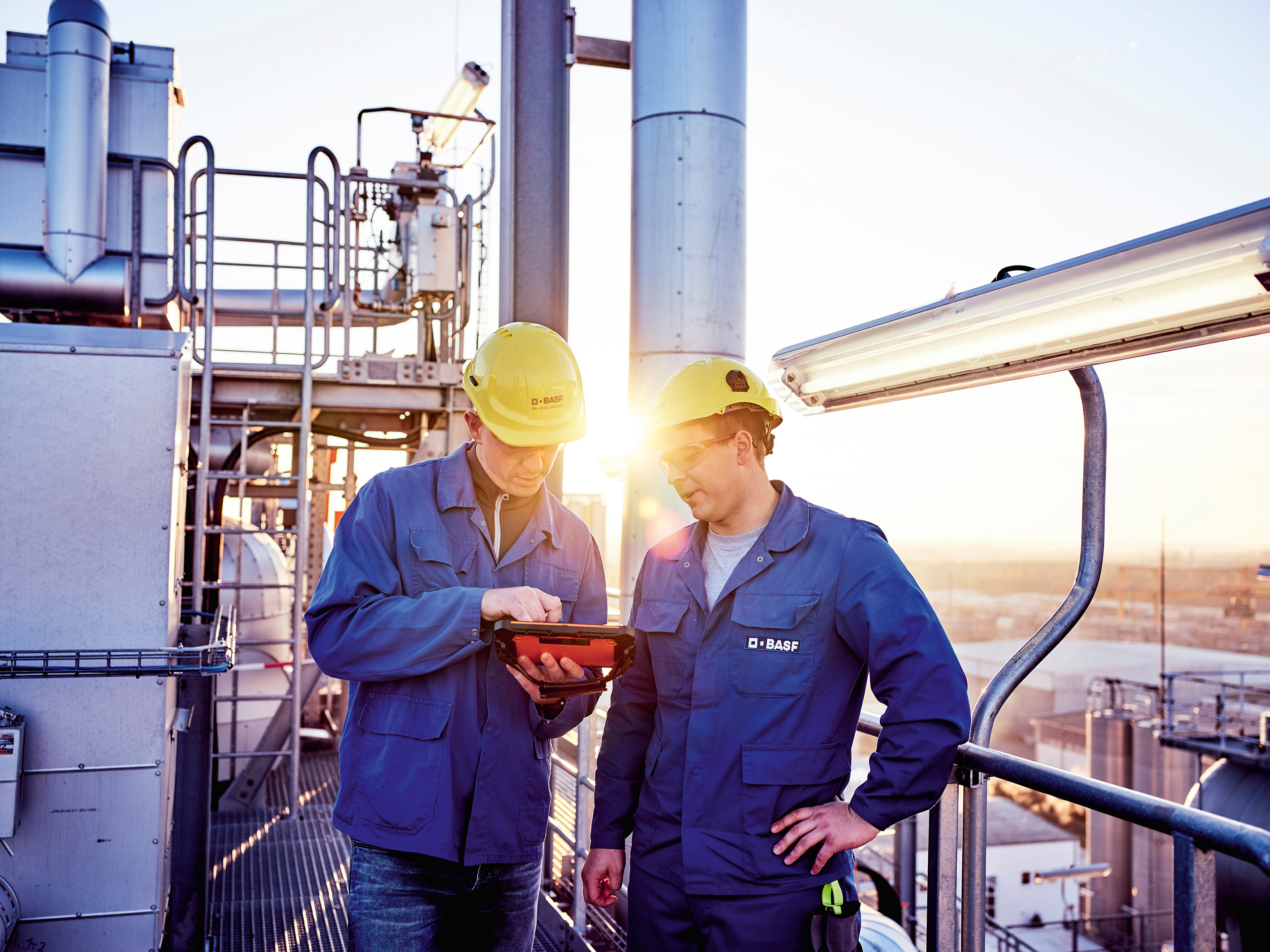 Master of Maintenance Christian Kieweg (l.) and Plant Operator Kevin Noack during inspection at a PBT plant on the production site of BASF Schwarzheide, Germany. A state-of-the art plant for the production of cathode materials is to be built at this site in 2022.