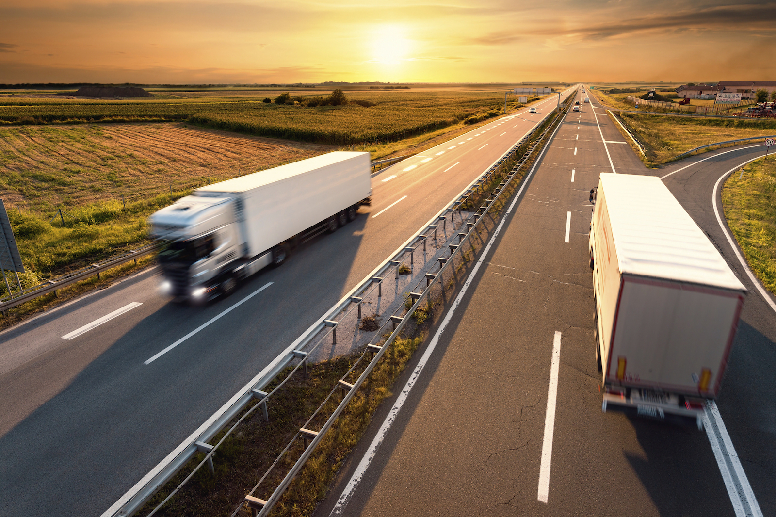 Two trucks on highway in motion blur